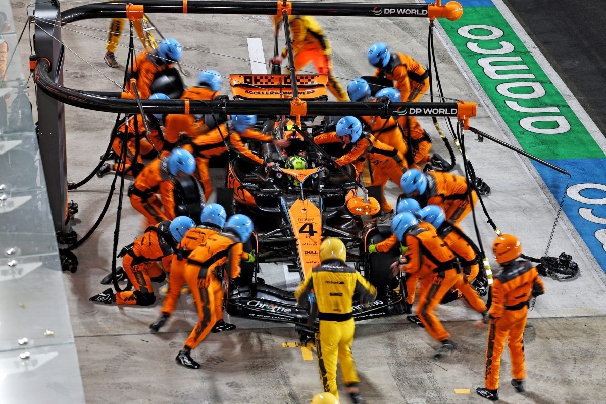 A Formula 1 pit crew changing tyres in a choreographed stop